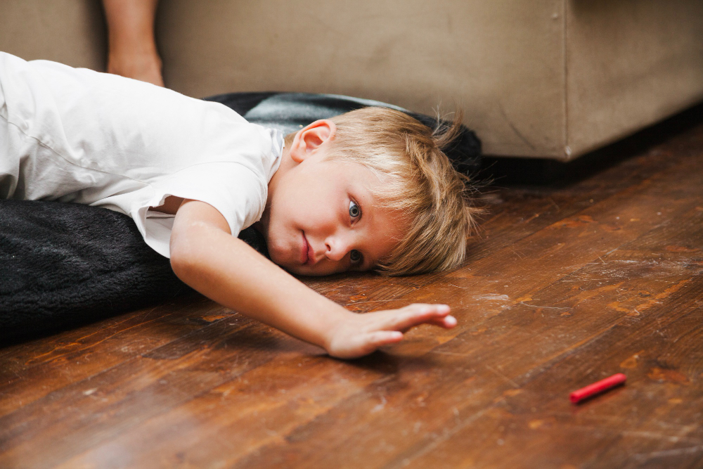 Boy laying on the floor day dreaming