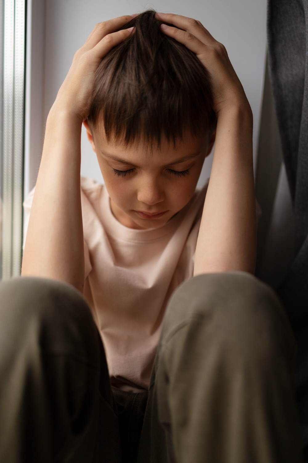 boy looking down sad