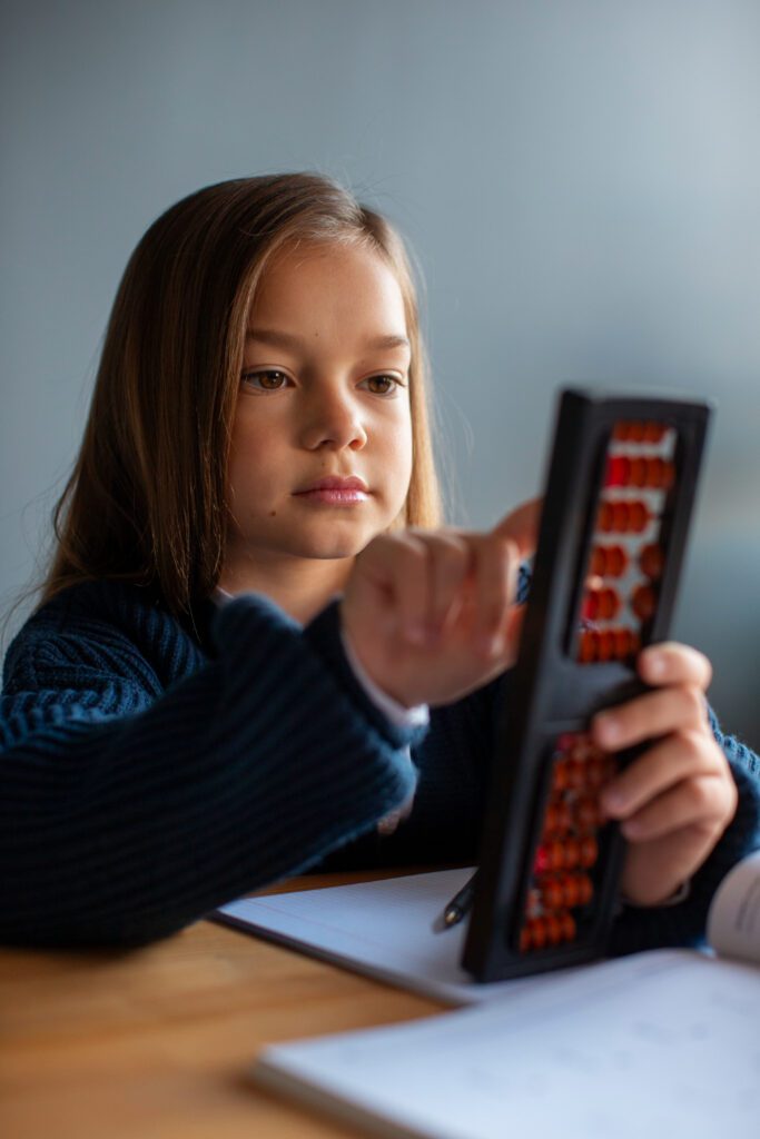 child learning math with abacus 
