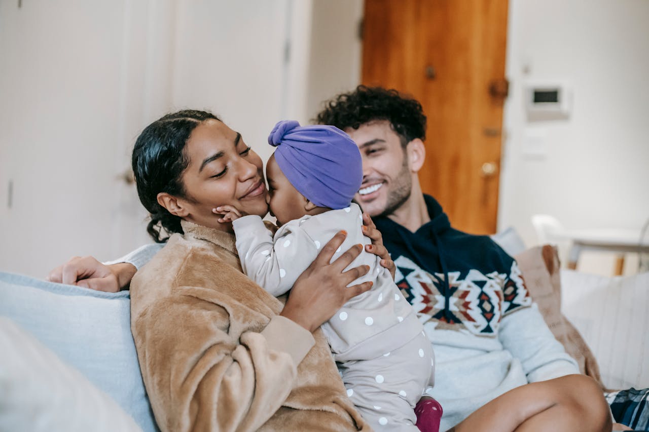 multiracial parents with cute little girl in living room