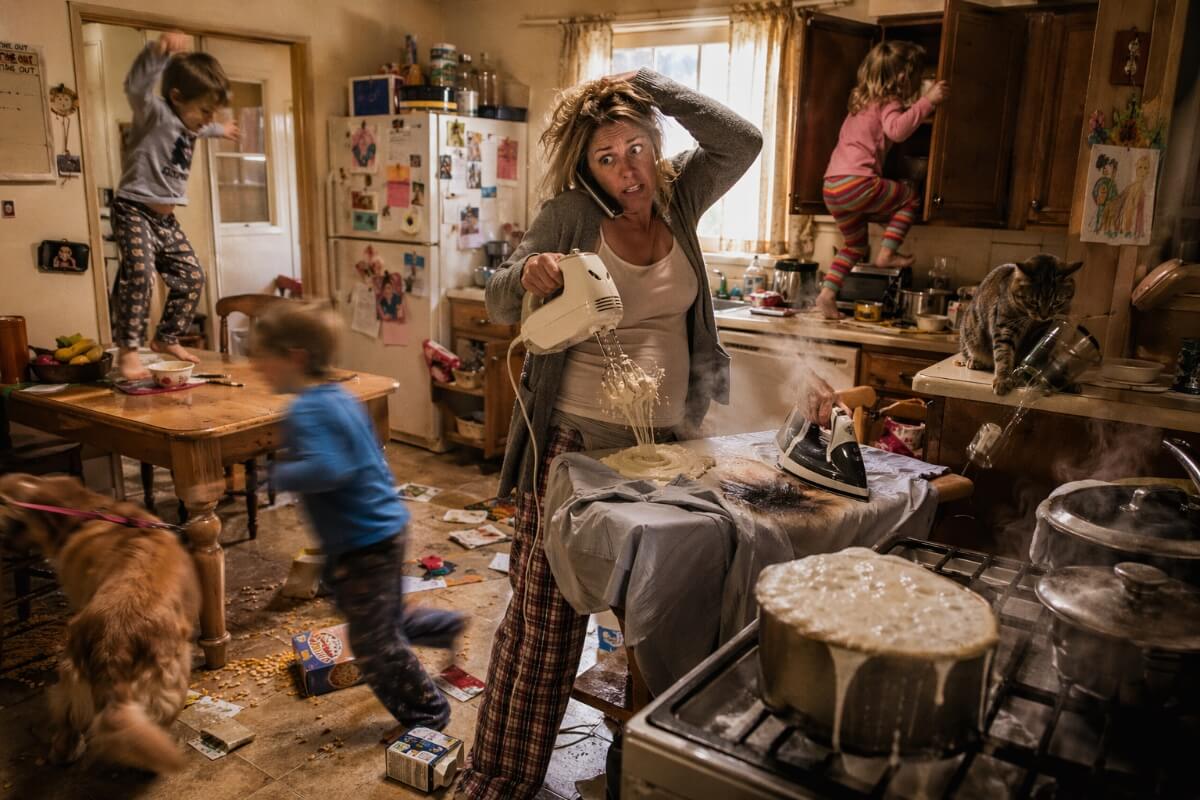 Woman in domestic terror situation with messy house and wild kids