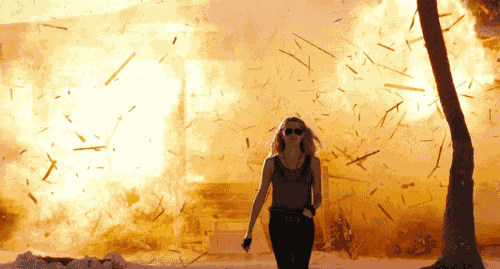 Woman walking away from burning building